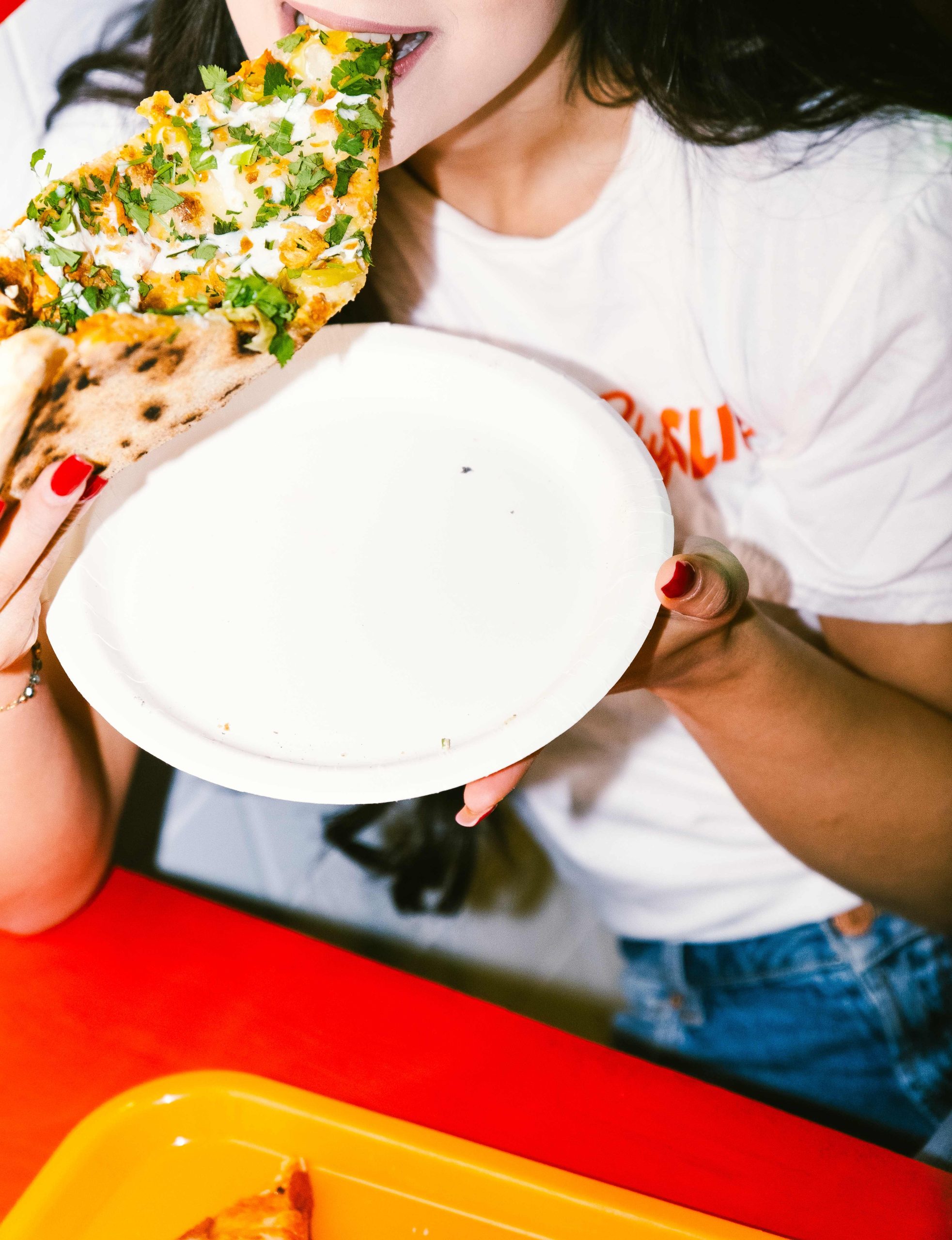 A girl eating a new york style slice of pizza A girl eating a new york style slice of pizza